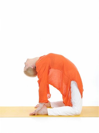 series or yoga photos. young woman in camel pose on yellow pilates mat Stock Photo - Budget Royalty-Free & Subscription, Code: 400-04353249