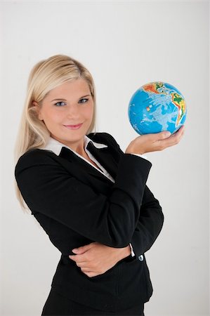 simsearch:400-05716348,k - Beautiful business woman in a suit with globe figure Foto de stock - Super Valor sin royalties y Suscripción, Código: 400-04353256
