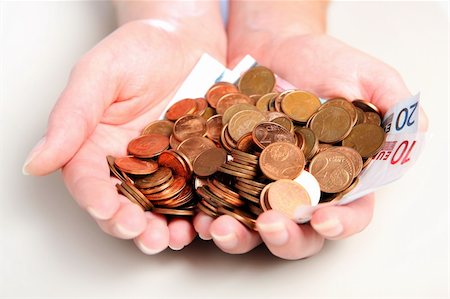 penique - A picture of a handful of money over white background Foto de stock - Super Valor sin royalties y Suscripción, Código: 400-04353575