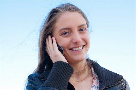 Outdoor portrait young woman talk on a cellular telephone Stock Photo - Budget Royalty-Free & Subscription, Code: 400-04353595