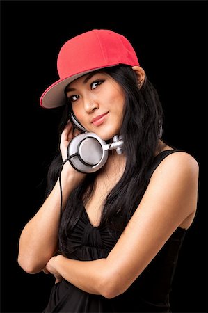 deejay (female) - A young asian girl in a black dress and red hat listening to music from dj style headphones. Stock Photo - Budget Royalty-Free & Subscription, Code: 400-04353829