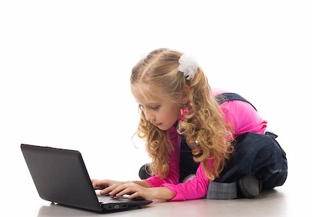 Young girl typing something on her own laptop Stock Photo - Budget Royalty-Free & Subscription, Code: 400-04353821