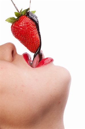 Beautiful girl eating a fresh red strawberry with chocolate sauce Stock Photo - Budget Royalty-Free & Subscription, Code: 400-04353877
