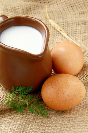 simsearch:400-04499805,k - Glass jug with milk and  eggs on natural background of rustic style Photographie de stock - Aubaine LD & Abonnement, Code: 400-04365240