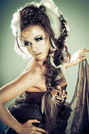 Vogue style portrait of a woman with gold-silver bodyart and makeup Stock Photo - Budget Royalty-Free & Subscription, Code: 400-04366220