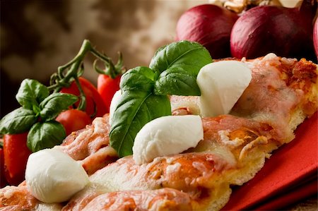 delicious slice of pizza with buffalo mozzarella on wooden table Stock Photo - Budget Royalty-Free & Subscription, Code: 400-04366400