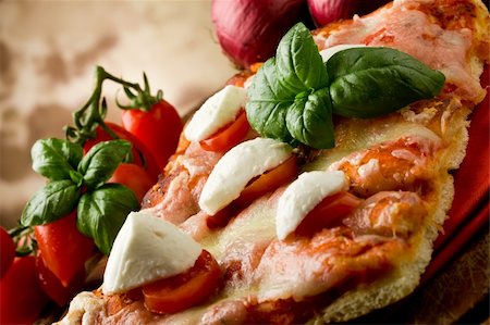 delicious slice of pizza with buffalo mozzarella and cherry tomatoes on wooden table Stock Photo - Budget Royalty-Free & Subscription, Code: 400-04366403