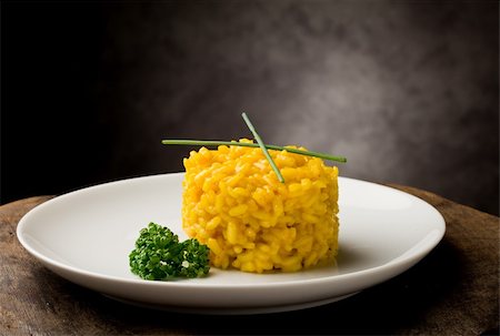 photo of delicious yellow risotto with saffron on wooden table Stockbilder - Microstock & Abonnement, Bildnummer: 400-04366439