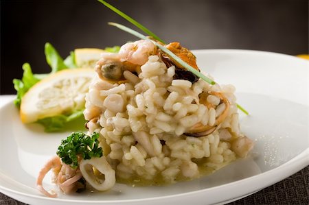 photo of delicious risotto with seafood and parsley on it Stockbilder - Microstock & Abonnement, Bildnummer: 400-04366447