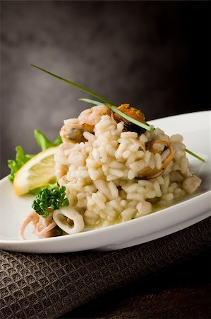 photo of delicious risotto with seafood and parsley on it Stockbilder - Microstock & Abonnement, Bildnummer: 400-04366448