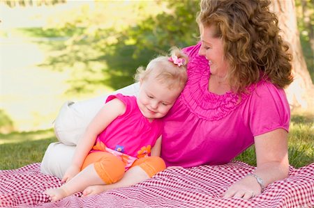 simsearch:400-06172843,k - Loving Moment with Attractive Mother and Adorable Daughter on Picnic Blanket in the Park. Stock Photo - Budget Royalty-Free & Subscription, Code: 400-04366650