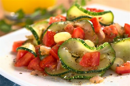 sauteeing - Sauteed zucchini slices, tomato cubes, onion and cooked corn grains with dried herbs and black pepper (Selective Focus, Focus on the front of the zucchini slice and tomato piece in the front) Photographie de stock - Aubaine LD & Abonnement, Code: 400-04366665