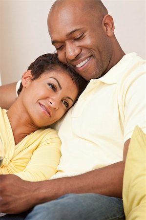 simsearch:400-04655735,k - A happy African American man and woman couple in their thirties sitting at home together smiling. Stockbilder - Microstock & Abonnement, Bildnummer: 400-04367208