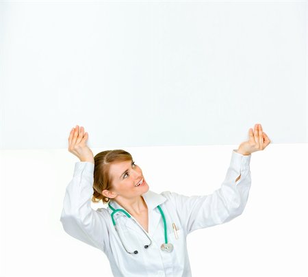 simsearch:400-05745246,k - Smiling medical doctor woman looking at blank billboard isolated on white Photographie de stock - Aubaine LD & Abonnement, Code: 400-04367295