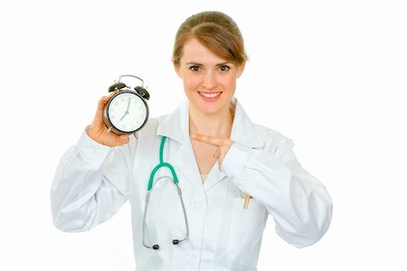 simsearch:400-04351236,k - Smiling  medical female doctor pointing finger on alarm clock isolated on white Photographie de stock - Aubaine LD & Abonnement, Code: 400-04367306