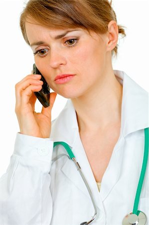 simsearch:400-04351236,k - Worried medical female doctor talking on mobile phone isolated on white Photographie de stock - Aubaine LD & Abonnement, Code: 400-04367300