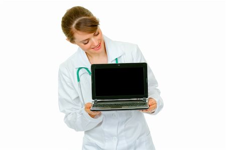 simsearch:400-04351236,k - Smiling  medical doctor woman looking on laptop with blank screen isolated on white Photographie de stock - Aubaine LD & Abonnement, Code: 400-04367301