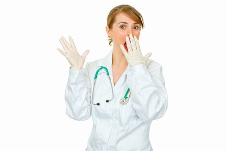 simsearch:400-04351236,k - Shocked female doctor in medical gloves holding hand near mouth isolated on white Photographie de stock - Aubaine LD & Abonnement, Code: 400-04367303