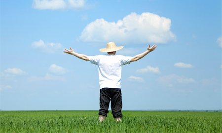 Farmer in hat at spring field. Stock Photo - Budget Royalty-Free & Subscription, Code: 400-04367532