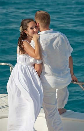 Newly married couple embracing while stood on the bow of a boat Stock Photo - Budget Royalty-Free & Subscription, Code: 400-04367634