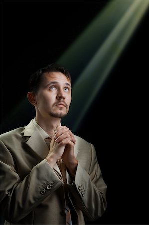 a young man in a suit, praying for something Foto de stock - Super Valor sin royalties y Suscripción, Código: 400-04368009