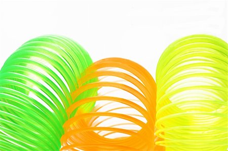 simsearch:400-07167932,k - Close up of colorful plastic springs on white background Foto de stock - Super Valor sin royalties y Suscripción, Código: 400-04360419