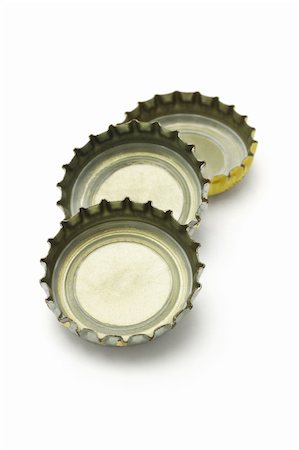 Three bottle caps lying on white background Stock Photo - Budget Royalty-Free & Subscription, Code: 400-04360431