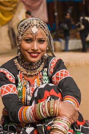 dancers of rajasthan - Beautiful Kalbelia dancer in ornate black costume trimmed with beads and sequins at the Sarujkund Fair near Delhi in India. Photographie de stock - Aubaine LD & Abonnement, Code: 400-04361128