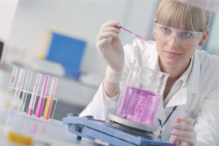 doctor student  female researcher holding up a test tube in chemistry bright labaratory Stock Photo - Budget Royalty-Free & Subscription, Code: 400-04361133