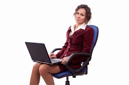 Business woman sitting on chair with laptop. Businesswoman in lounge suit sitting in the office chair and holding laptop. Foto de stock - Super Valor sin royalties y Suscripción, Código: 400-04361296