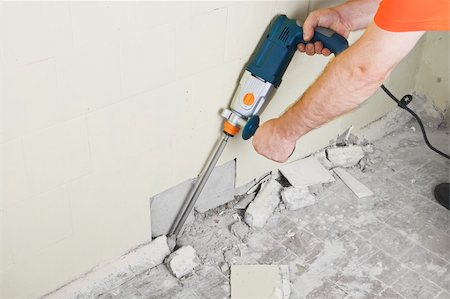 drilling (activity) - House-builder in uniform working with a plugger. Photographie de stock - Aubaine LD & Abonnement, Code: 400-04362411