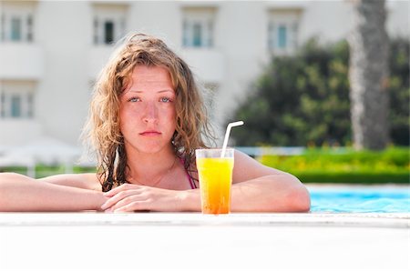 sad pretty bored woman is boring in the hotel swimming pool Stock Photo - Budget Royalty-Free & Subscription, Code: 400-04374338