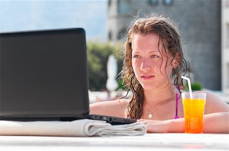 woman is using laptop from swimming pool near the hotel Stock Photo - Budget Royalty-Free & Subscription, Code: 400-04374333