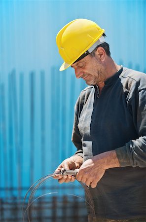 Authentic construction worker cutting reinforcement binding wire with a pair of pliers Stock Photo - Budget Royalty-Free & Subscription, Code: 400-04374868