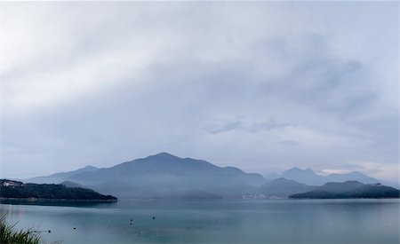 simsearch:693-03317521,k - Panoramic landscape of lake with mountain under cloudy sky, famous attraction, Sun Moon Lake situated in Yuchi, Nantou, Taiwan, Asia. Stock Photo - Budget Royalty-Free & Subscription, Code: 400-04374885