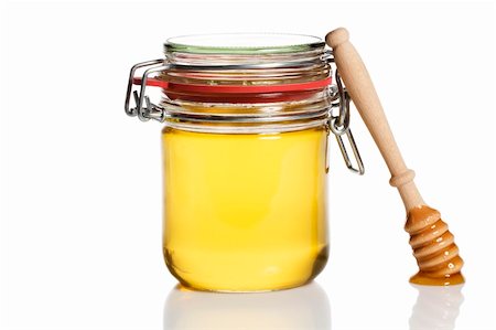 simsearch:400-06640106,k - honey covered honey dipper leaning at a honey jar on white background Stock Photo - Budget Royalty-Free & Subscription, Code: 400-04375004