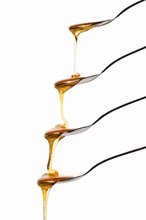 simsearch:400-04865454,k - honey falling over four spoons on white background Stockbilder - Microstock & Abonnement, Bildnummer: 400-04375013