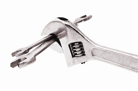 simsearch:400-04865679,k - Adjustable wrench gripping a pair of spanners on white background Foto de stock - Super Valor sin royalties y Suscripción, Código: 400-04375506