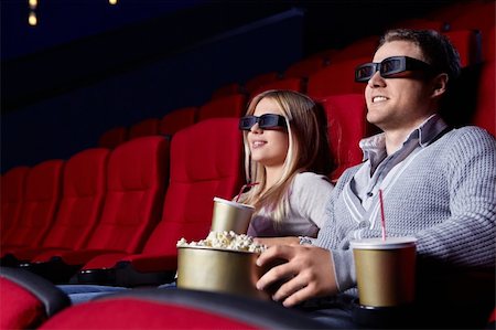Attractive young couple in 3D glasses watching movies in cinema Stock Photo - Budget Royalty-Free & Subscription, Code: 400-04375704