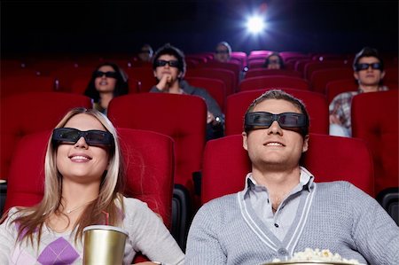 Attractive young people in 3D glasses watching a movie at the cinema Stock Photo - Budget Royalty-Free & Subscription, Code: 400-04375706