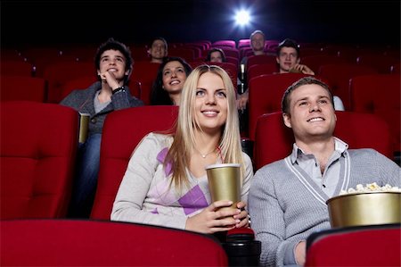 Attractive people are watching a movie at the cinema Stock Photo - Budget Royalty-Free & Subscription, Code: 400-04375708