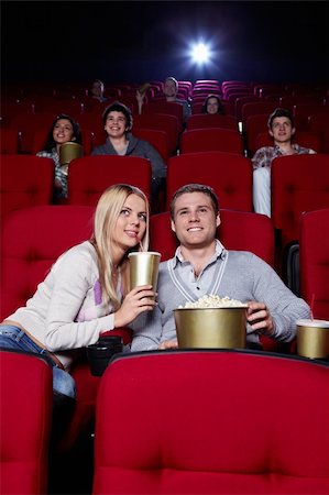 Attractive young people are watching movies in cinema Stock Photo - Budget Royalty-Free & Subscription, Code: 400-04375702