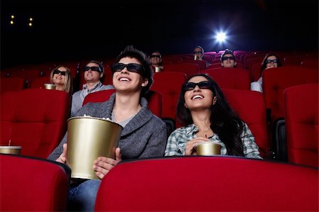 Funny people are watching a movie in 3D glasses in cinema Stock Photo - Budget Royalty-Free & Subscription, Code: 400-04375714