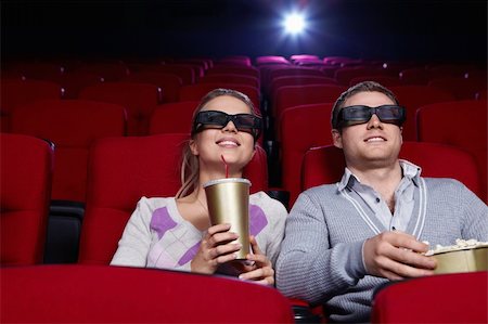 Attractive couple in 3D glasses watching movies in cinema Stock Photo - Budget Royalty-Free & Subscription, Code: 400-04375724