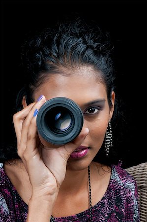 peeping fashion - portrait of a beautiful woman of east indian descent looking through a dslr lens Stock Photo - Budget Royalty-Free & Subscription, Code: 400-04376448