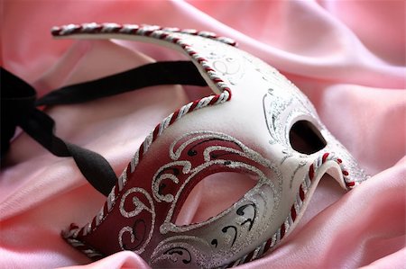 Carnival mask over pink satin, shallow depth of field Stock Photo - Budget Royalty-Free & Subscription, Code: 400-04376665