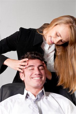 young businesswoman is making head massage to her teammate Stock Photo - Budget Royalty-Free & Subscription, Code: 400-04376682