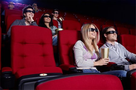 Smiling people watch movies in cinema Stock Photo - Budget Royalty-Free & Subscription, Code: 400-04377550