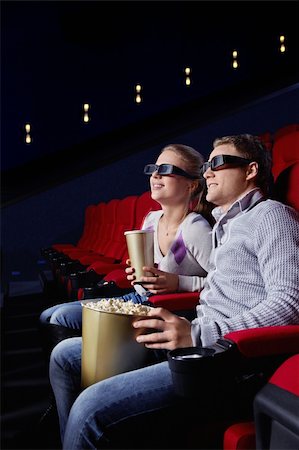 Young couple watching a movie in the cinema Stock Photo - Budget Royalty-Free & Subscription, Code: 400-04377569