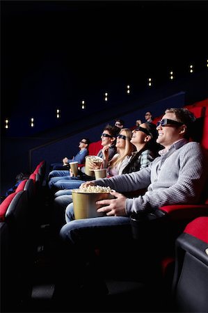 Young smiling people watch movies in cinema Stock Photo - Budget Royalty-Free & Subscription, Code: 400-04377562